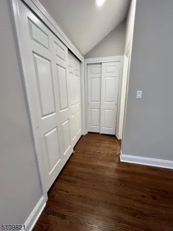 a view of a room with wooden floor
