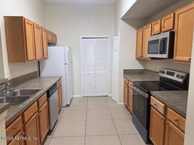 7920 Merrill Road, Unit 2004 Jacksonville, FL 32277 - Photo 2 of 13 a kitchen with stainless steel appliances granite countertop a sink stove and refrigerator