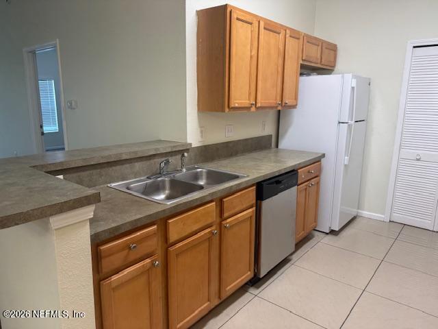7920 Merrill Road, Unit 2004 Jacksonville, FL 32277 - Photo 3 of 13 a kitchen with stainless steel appliances granite countertop a sink and a refrigerator