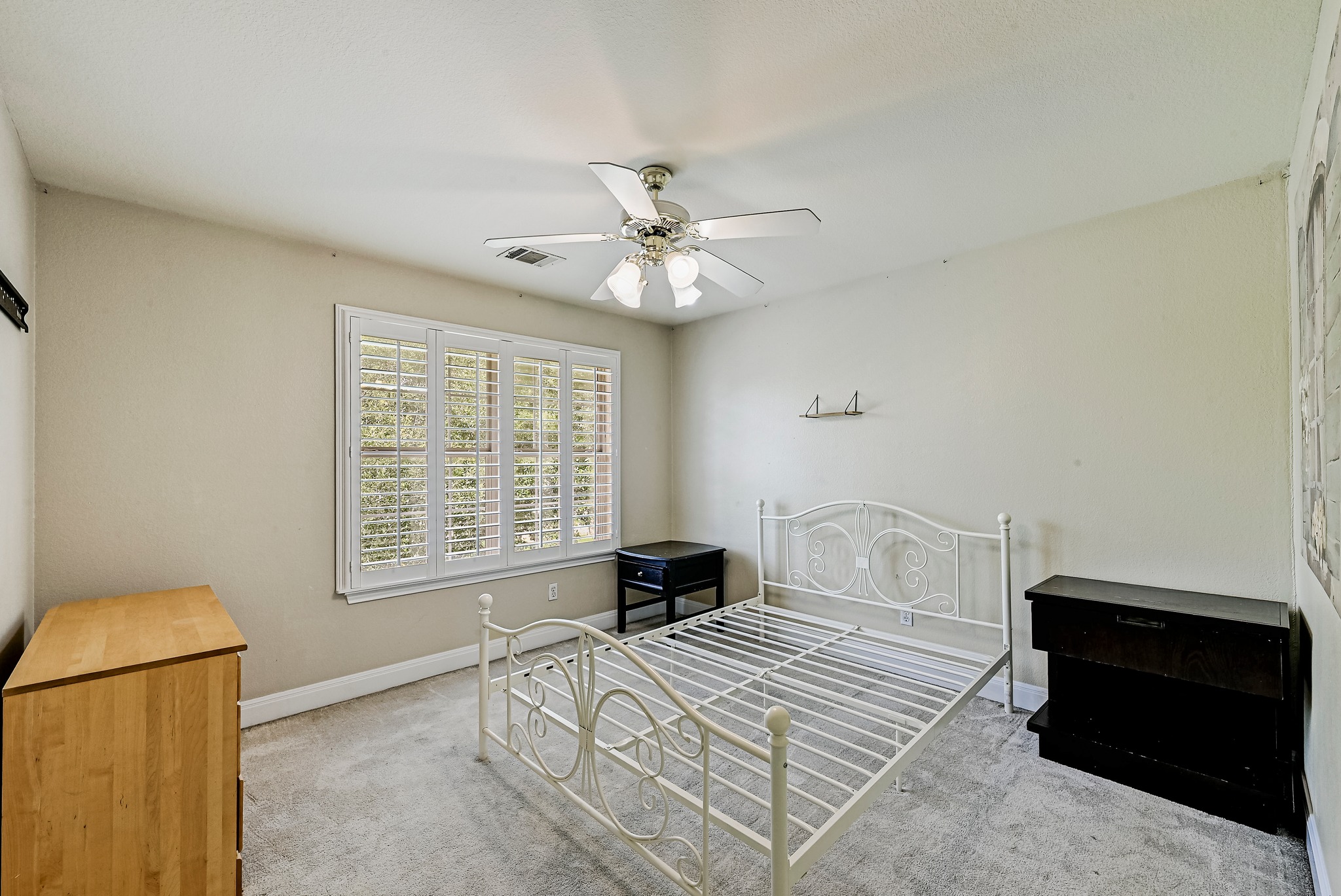2408 Amen Corner Road Pflugerville, TX 78660 - Photo 28 of 40 Bright room featuring a multi-pane window with white plantation shutters, a ceiling fan with integrated lighting, and neutral wall tones