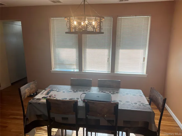 a dining room with a table chairs and a chandelier
