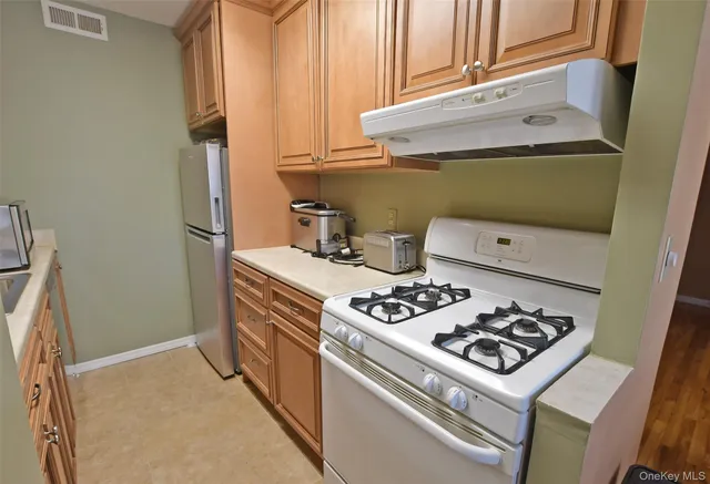 a kitchen with a stove and a refrigerator