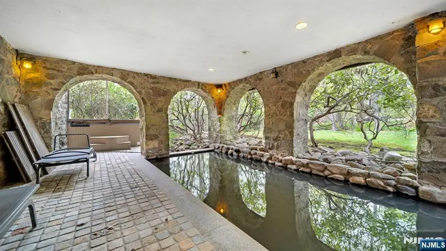 a view of a lake with a table and chairs under an umbrella