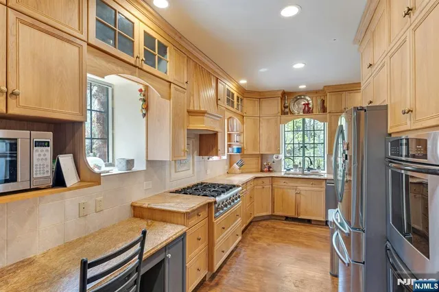 a kitchen with granite countertop a sink stove and cabinets