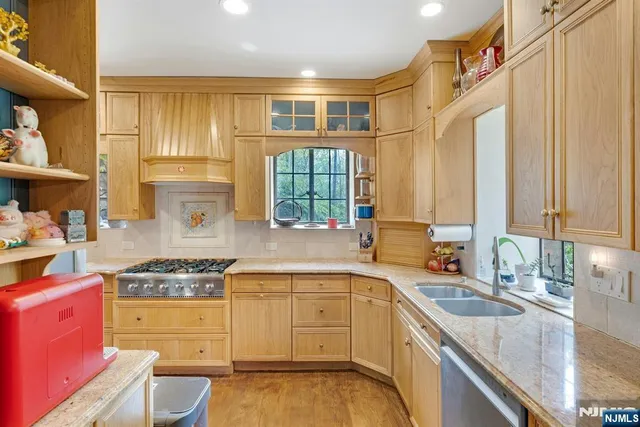 a kitchen with a sink and chairs