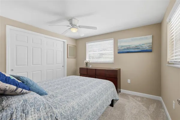 a bedroom with a large bed and a window