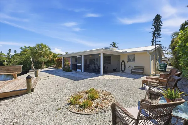 a view of a house with a yard and sitting area