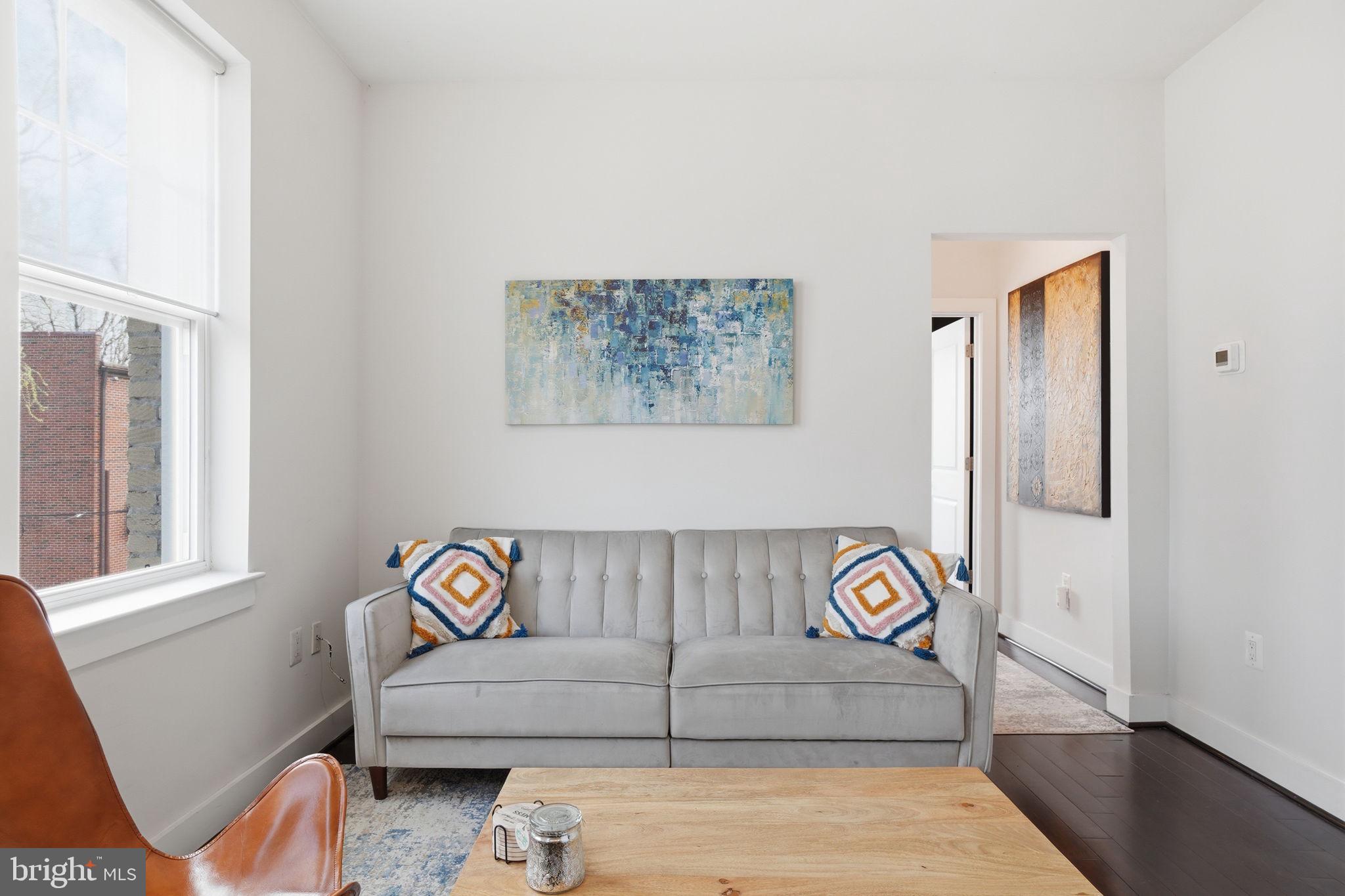 315 G Street Northeast, Unit 306 Washington, DC 20002 - Photo 2 of 14 a view of livingroom with furniture and workspace