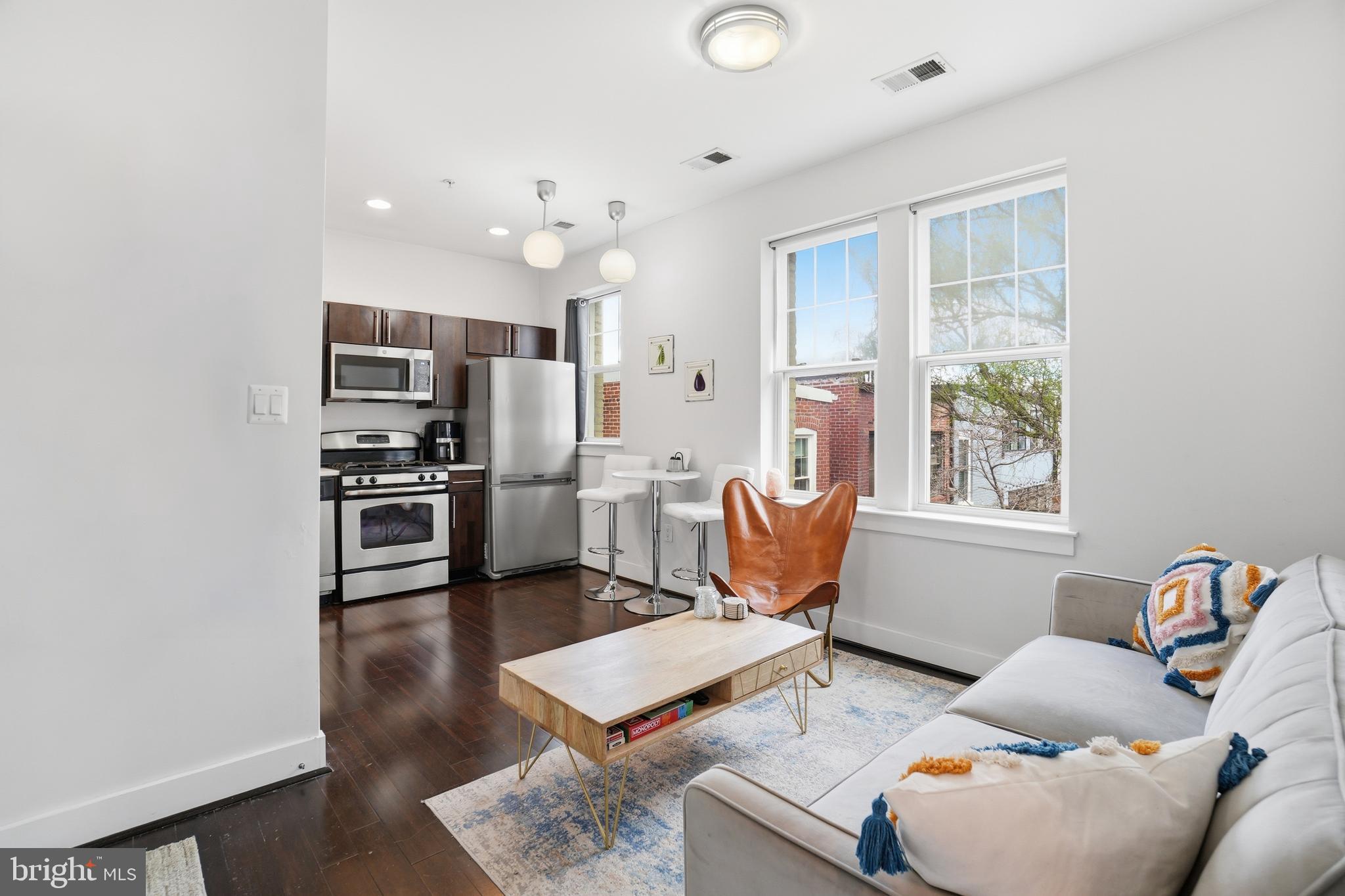 315 G Street Northeast, Unit 306 Washington, DC 20002 - Photo 4 of 14 a living room with furniture appliances and a window
