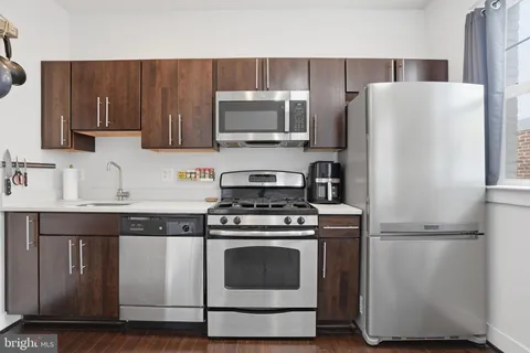 a kitchen with a stove microwave and refrigerator