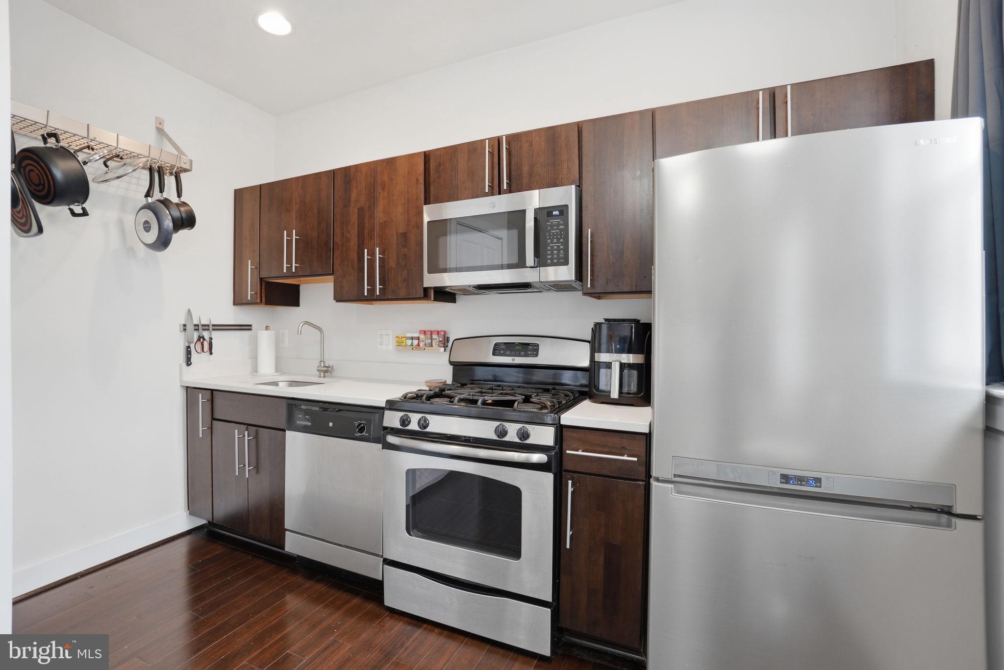 315 G Street Northeast, Unit 306 Washington, DC 20002 - Photo 8 of 14 a kitchen with stainless steel appliances a refrigerator sink and microwave