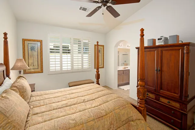 a bedroom with a bed dresser and a window