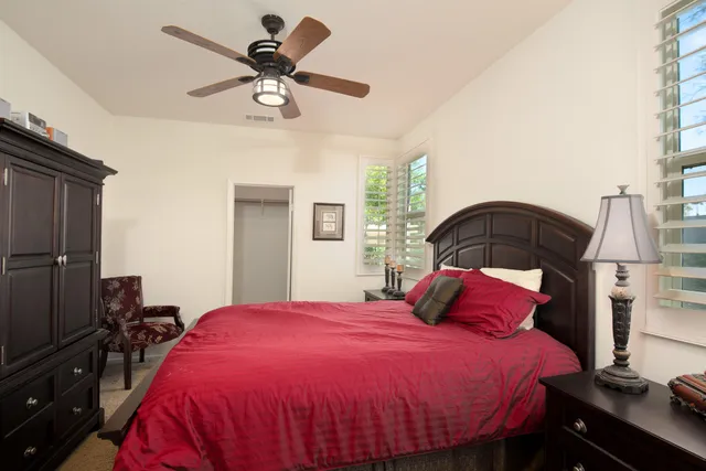 a bedroom with a bed and window
