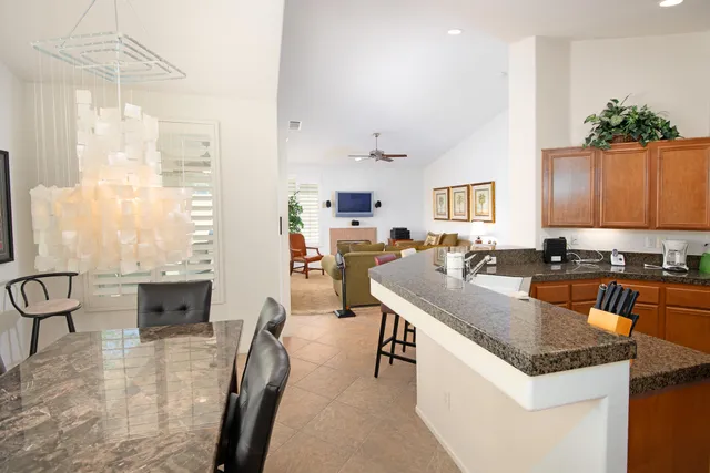 a kitchen with granite countertop lots of counter top space and living room