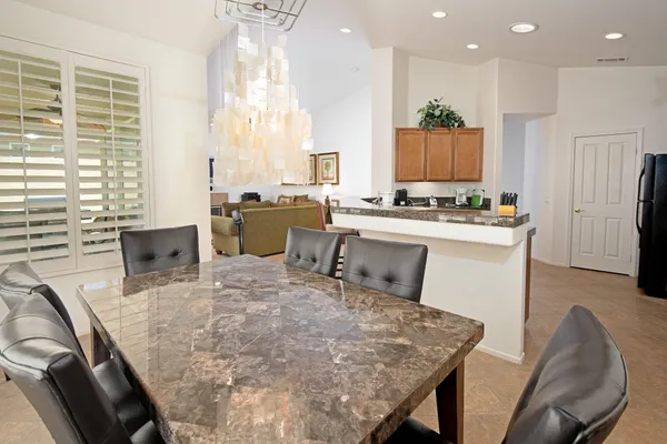 a large kitchen with a table and chairs