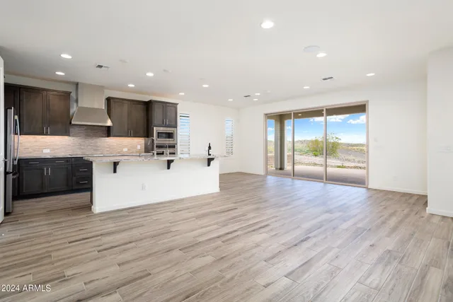 a view of kitchen with cabinets microwave and stove