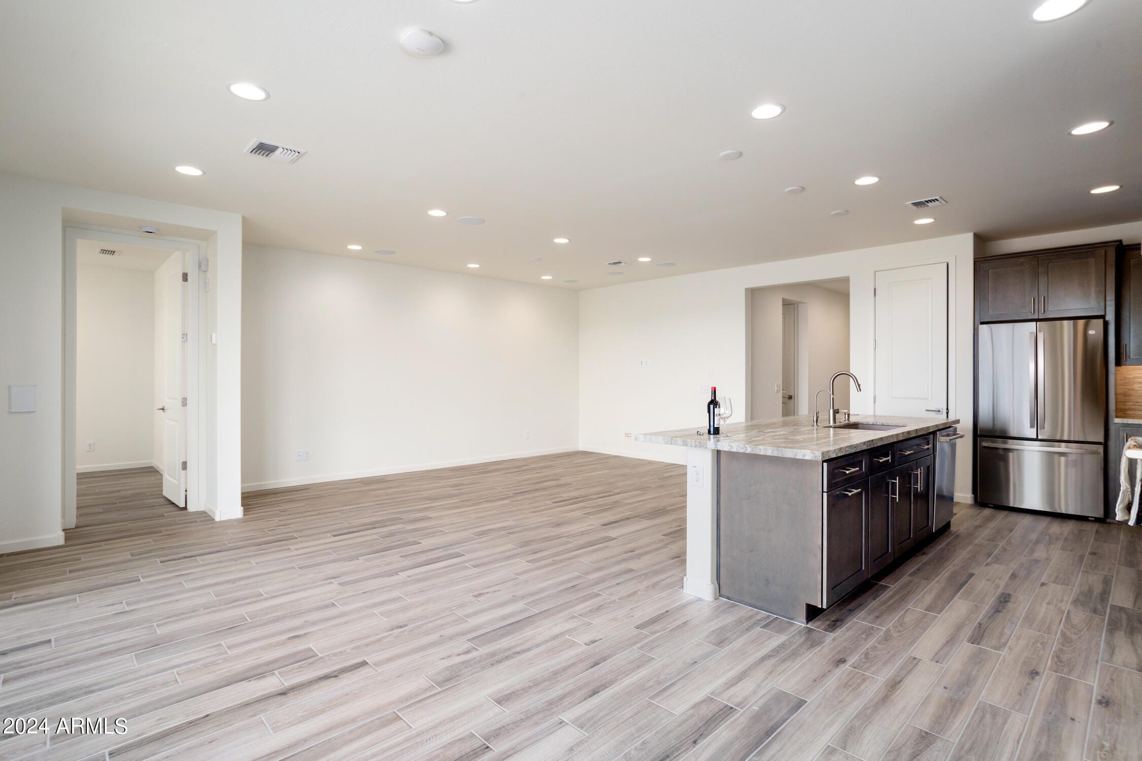 4092 Prairie Schooner Road Wickenburg, AZ 85390 - Photo 13 of 30 a large kitchen with stainless steel appliances granite countertop a large counter top and wooden floors