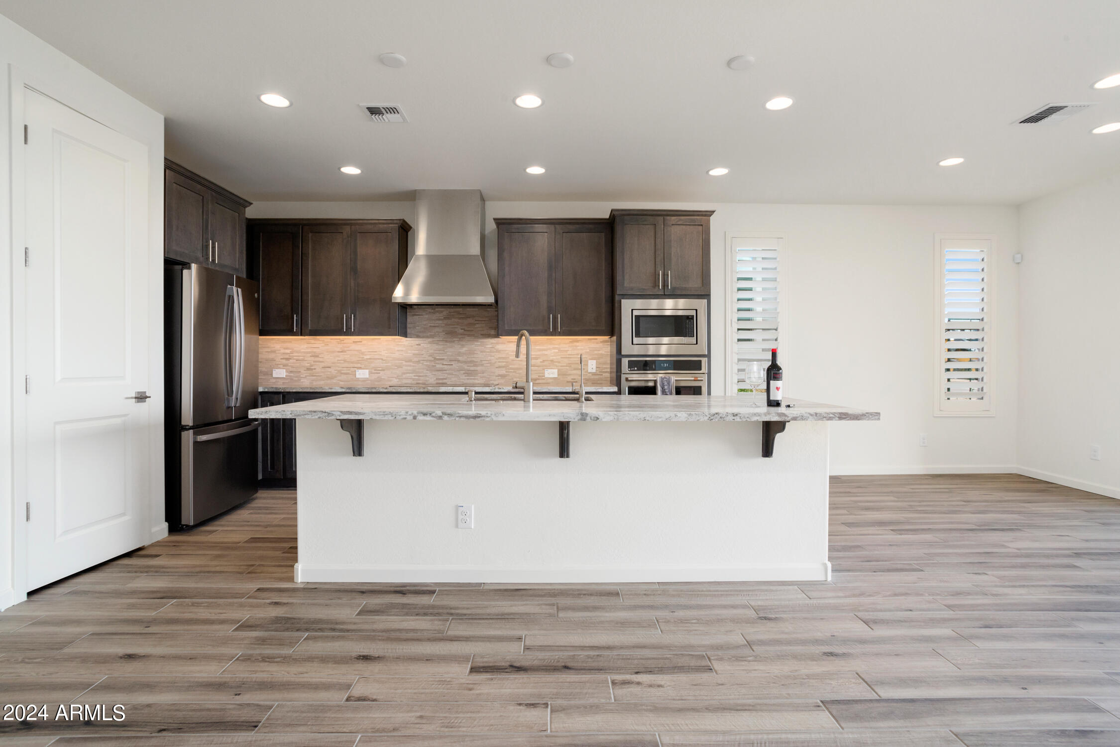 4092 Prairie Schooner Road Wickenburg, AZ 85390 - Photo 14 of 30 a view of kitchen with stainless steel appliances kitchen island a stove a refrigerator a oven and a sink