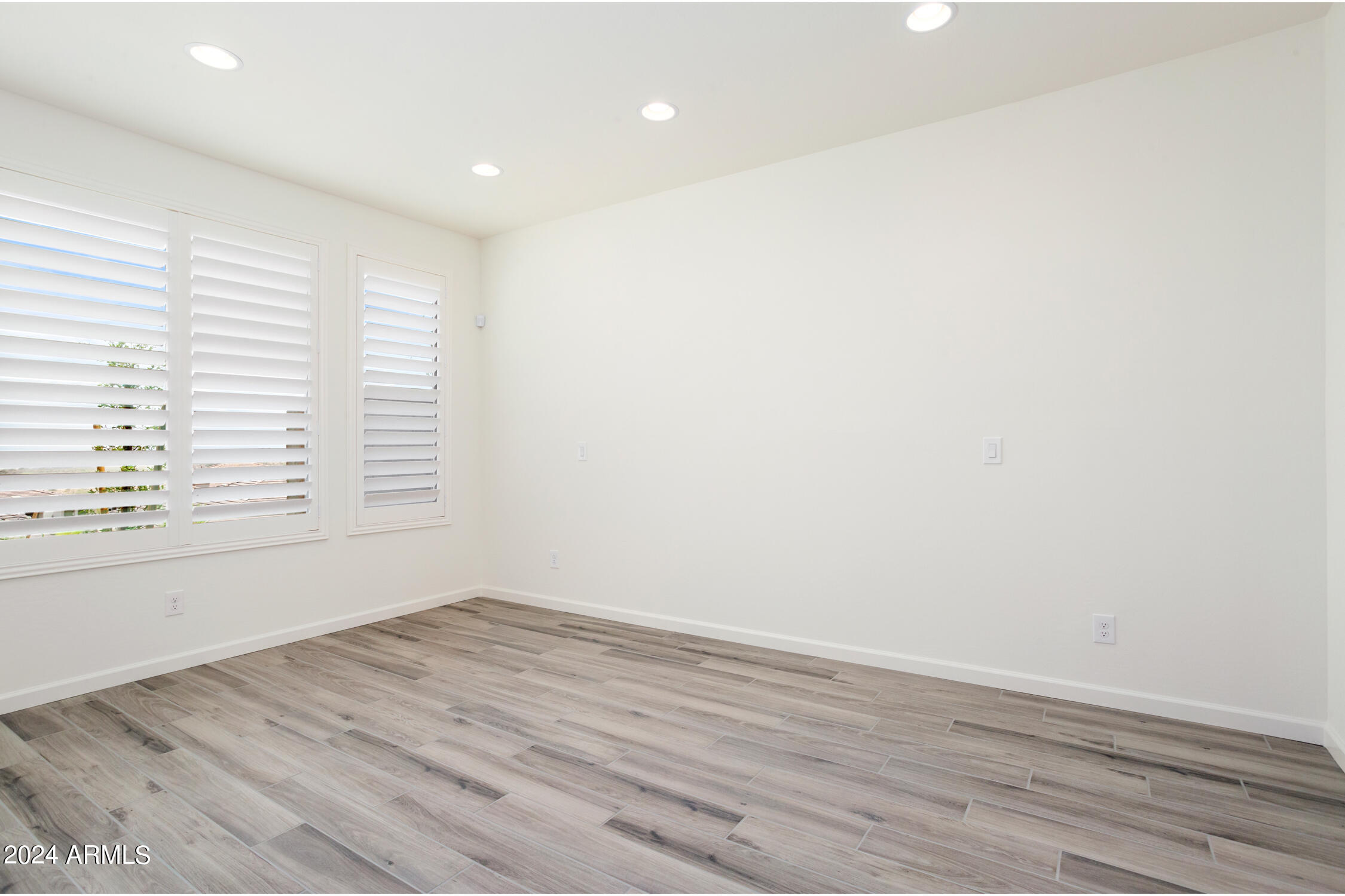 4092 Prairie Schooner Road Wickenburg, AZ 85390 - Photo 19 of 30 an empty room with wooden floor and windows