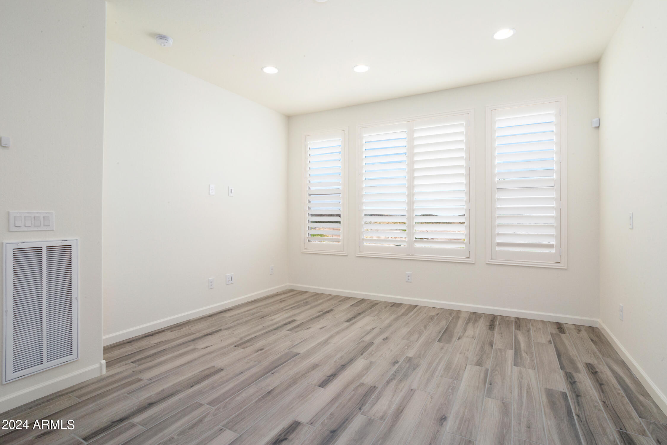 4092 Prairie Schooner Road Wickenburg, AZ 85390 - Photo 21 of 30 wooden floor in an empty room with a window