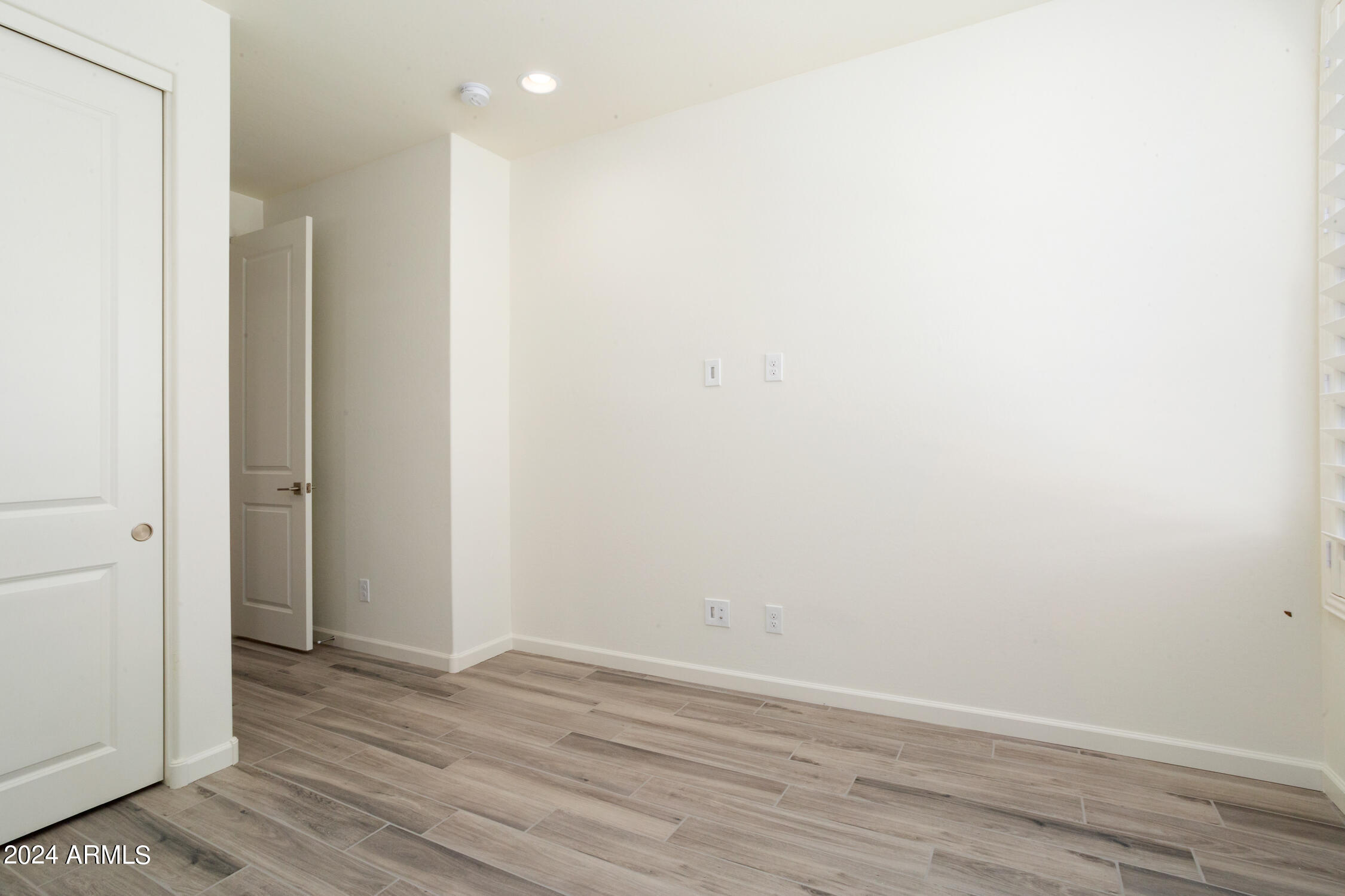 4092 Prairie Schooner Road Wickenburg, AZ 85390 - Photo 25 of 30 a view of an empty room with wooden floor