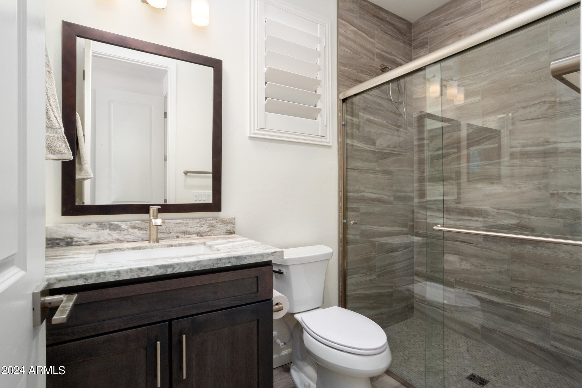4092 Prairie Schooner Road Wickenburg, AZ 85390 - Photo 26 of 30 a bathroom with a granite countertop sink toilet and shower