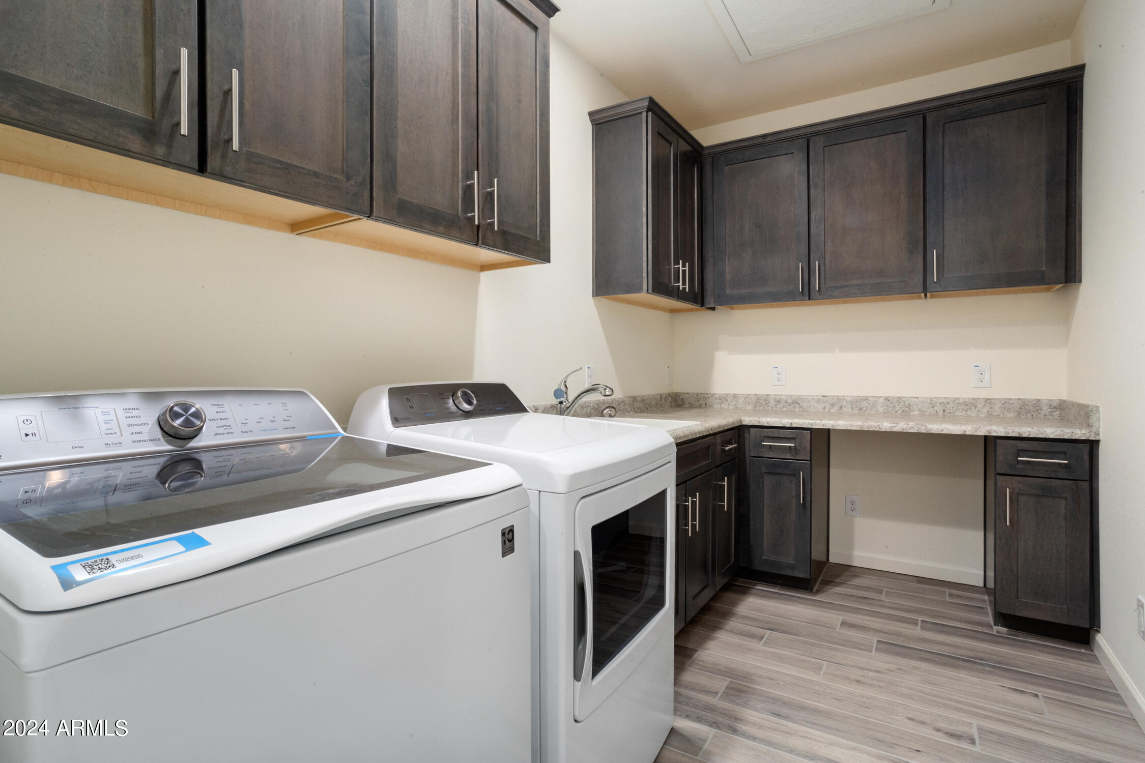 4092 Prairie Schooner Road Wickenburg, AZ 85390 - Photo 29 of 30 a utility room with sink dryer and cabinets
