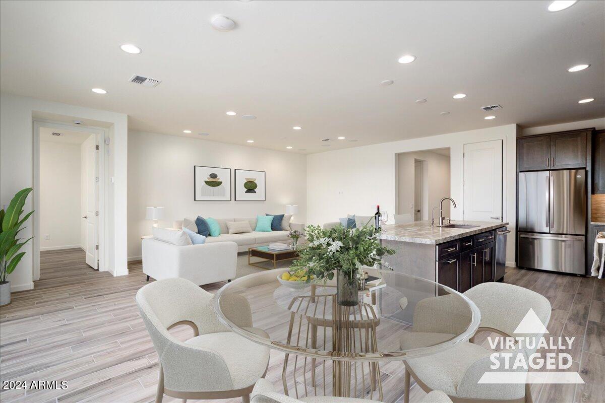 4092 Prairie Schooner Road Wickenburg, AZ 85390 - Photo 3 of 30 a living room with furniture potted plant and kitchen view