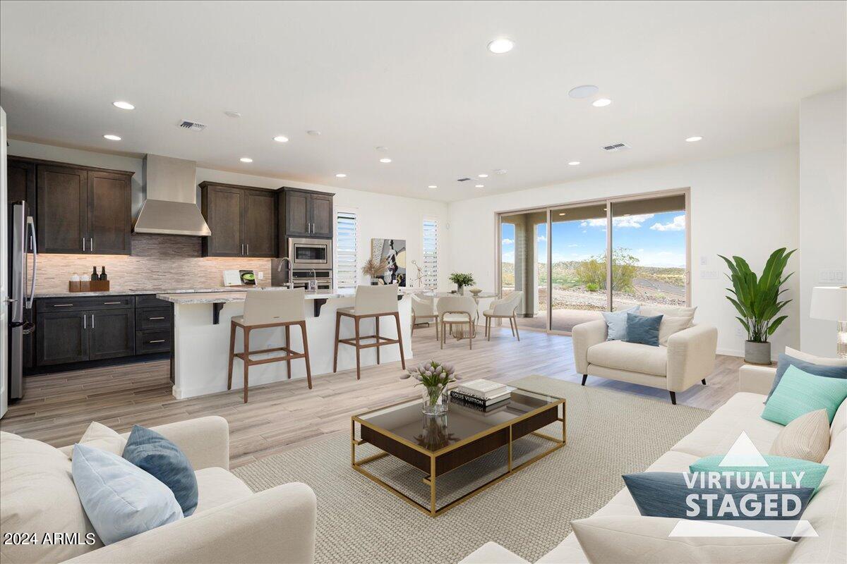 4092 Prairie Schooner Road Wickenburg, AZ 85390 - Photo 4 of 30 a living room with furniture kitchen view and a large window