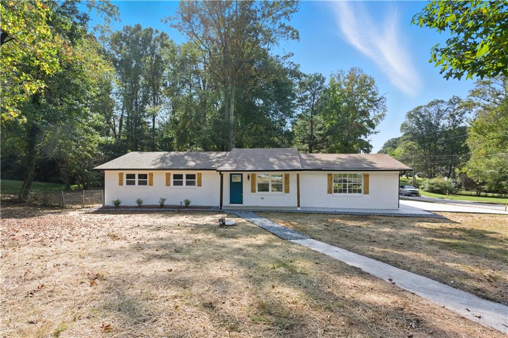 2087 Chestnut Way Lithia Springs, GA 30122 - Photo 1 of 28 a front view of a house with a garden