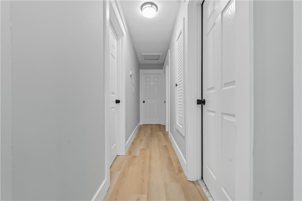 2087 Chestnut Way Lithia Springs, GA 30122 - Photo 15 of 28 a view of a hallway with wooden floor and staircase
