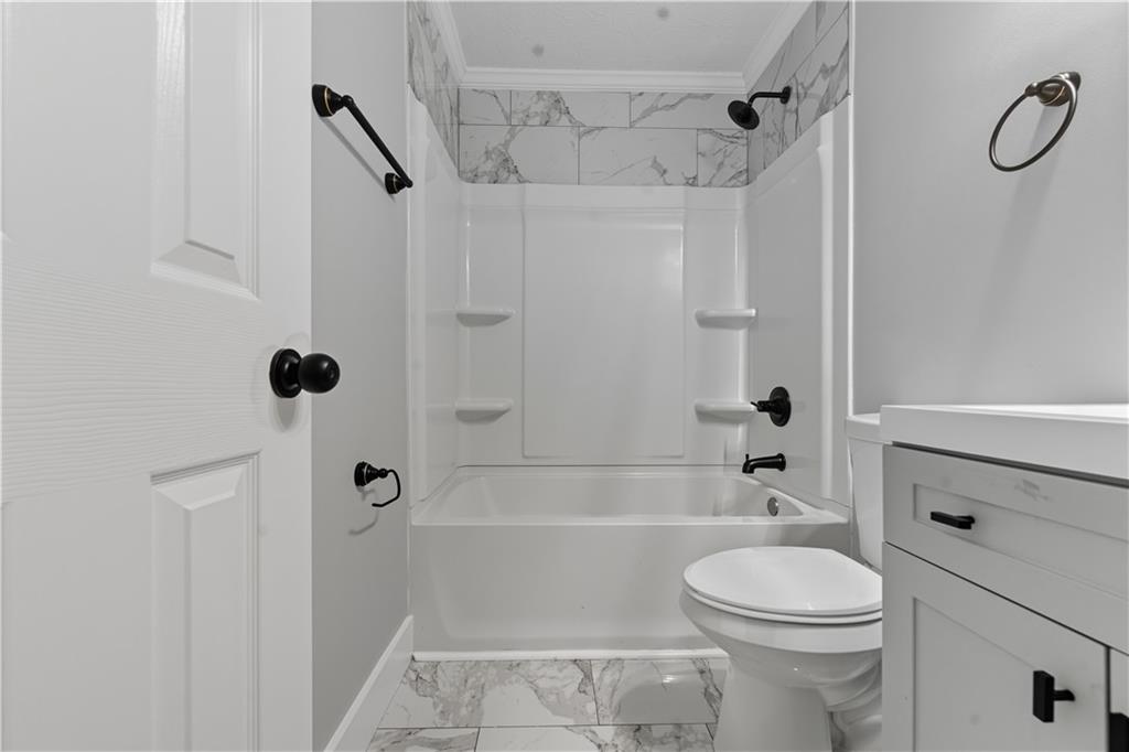 2087 Chestnut Way Lithia Springs, GA 30122 - Photo 17 of 28 a bathroom with a toilet a sink and shower