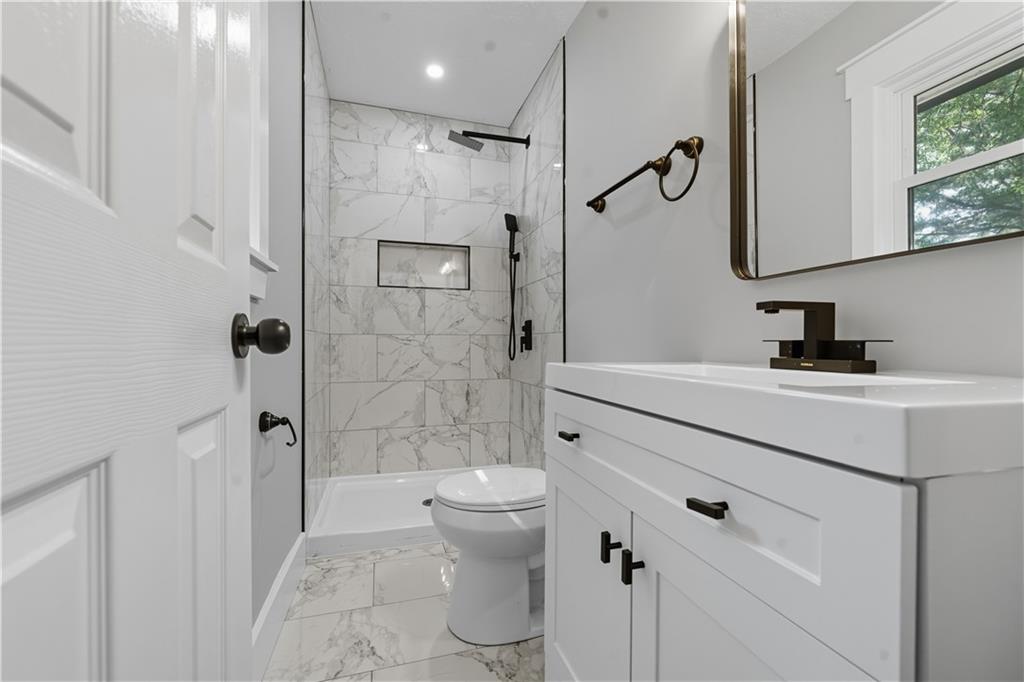 2087 Chestnut Way Lithia Springs, GA 30122 - Photo 20 of 28 a bathroom with a sink a toilet and shower