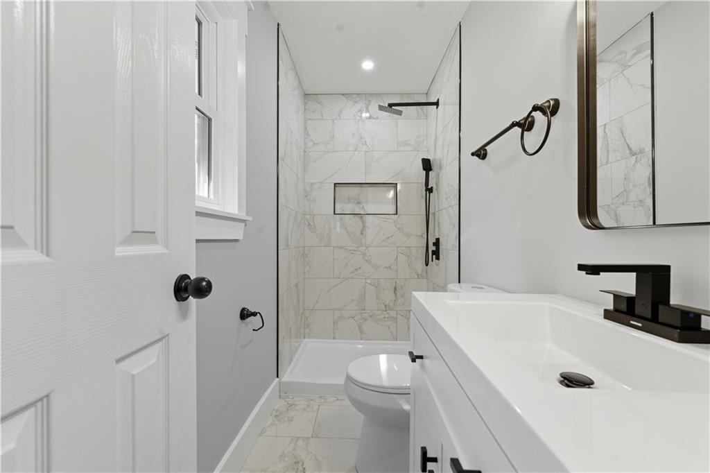 2087 Chestnut Way Lithia Springs, GA 30122 - Photo 21 of 28 a bathroom with a sink a toilet and shower