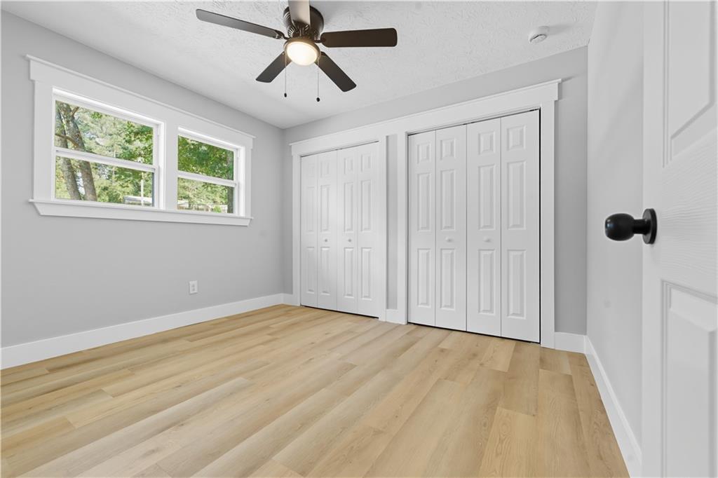 2087 Chestnut Way Lithia Springs, GA 30122 - Photo 22 of 28 wooden floor in an empty room with a window