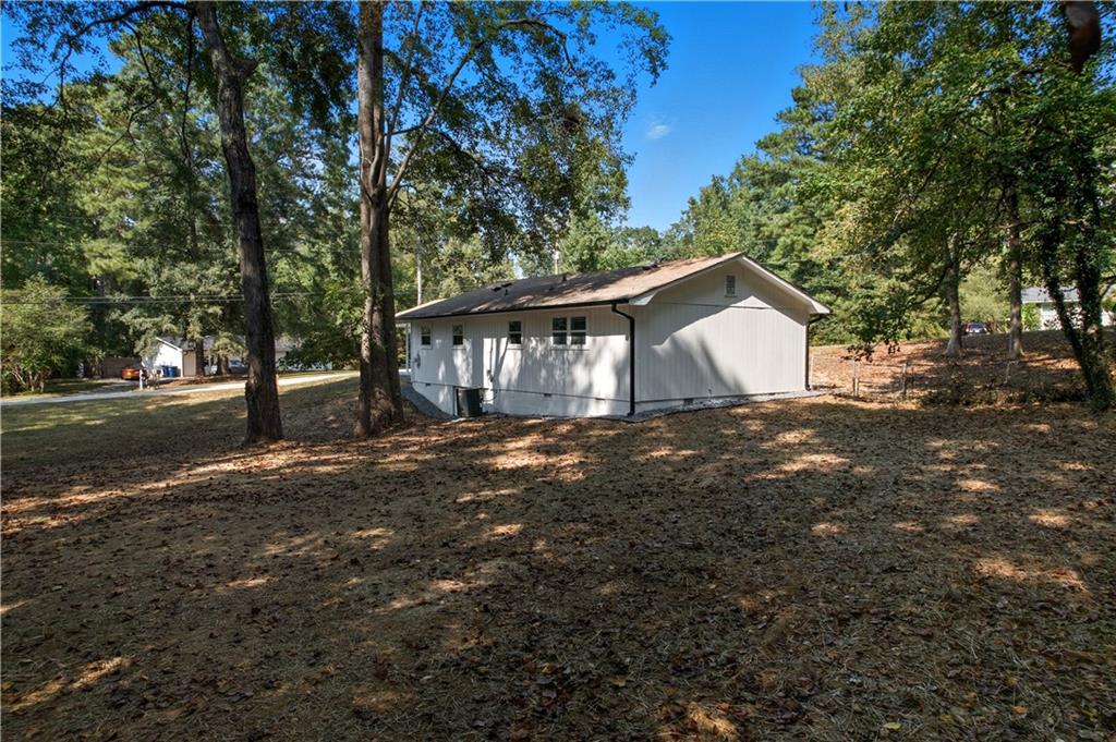 2087 Chestnut Way Lithia Springs, GA 30122 - Photo 25 of 28 a view of a house with backyard and tree