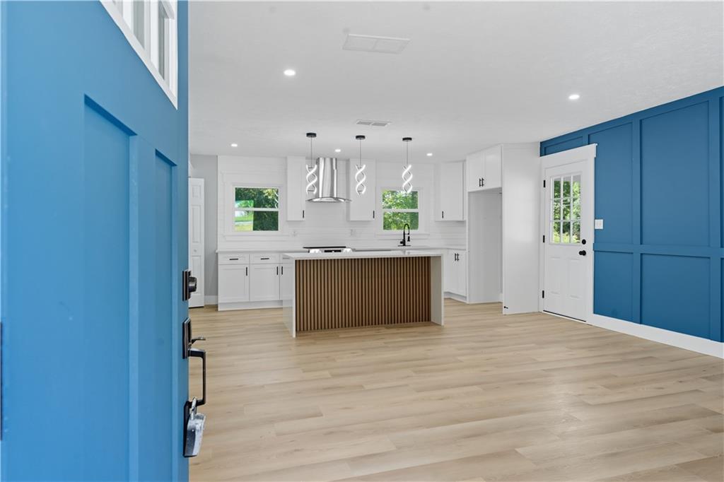 2087 Chestnut Way Lithia Springs, GA 30122 - Photo 5 of 28 a view of kitchen with kitchen island a sink wooden floor and a refrigerator