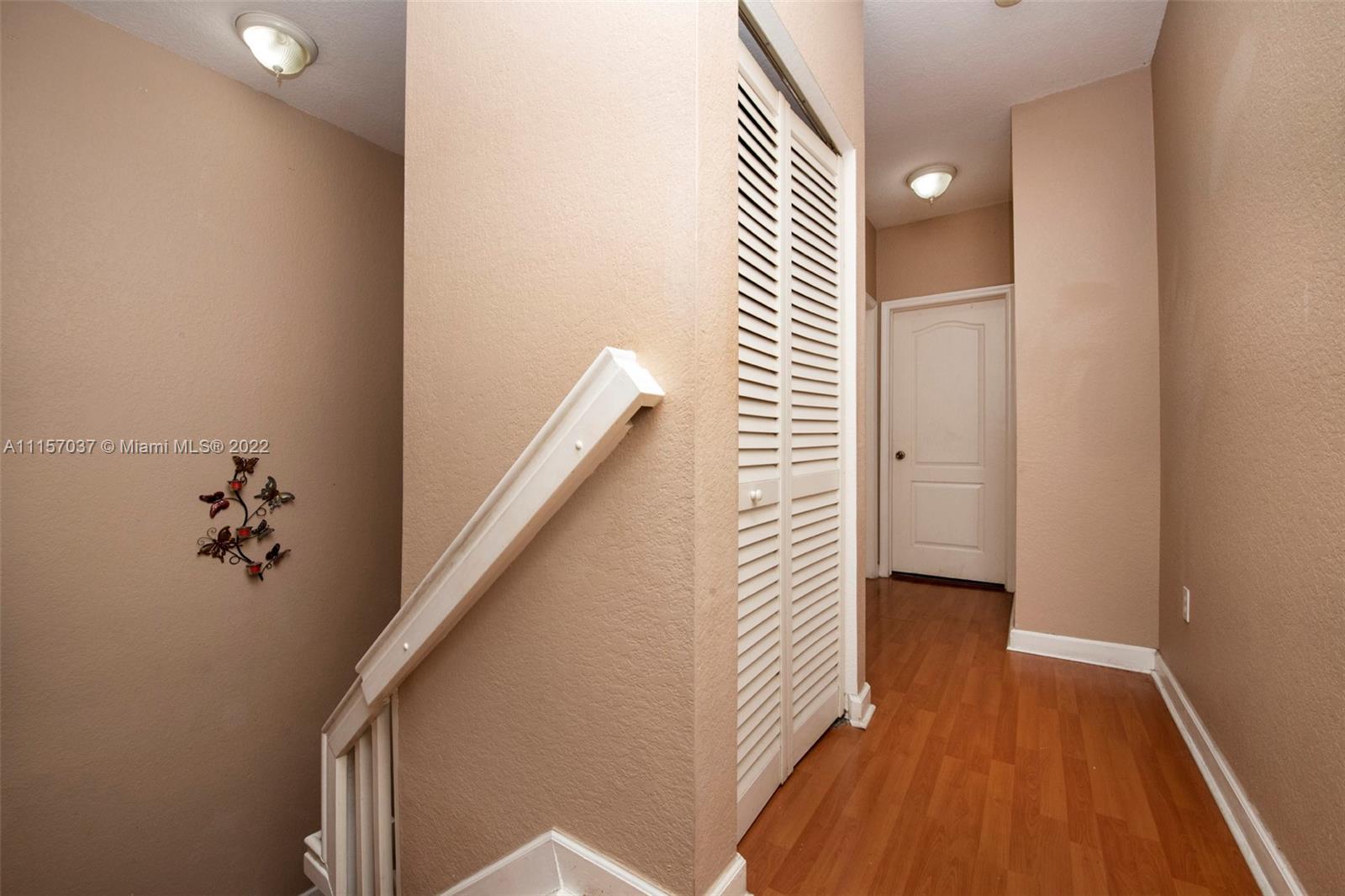 14738 Southwest 9th Lane Miami, FL 33194 - Photo 12 of 30 a view of a hallway with wooden floor and staircase