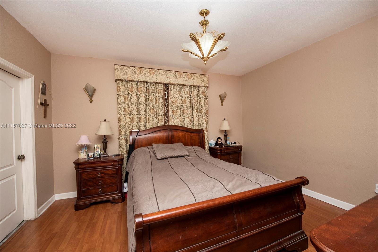 14738 Southwest 9th Lane Miami, FL 33194 - Photo 13 of 30 a bedroom with a bed and wooden floor