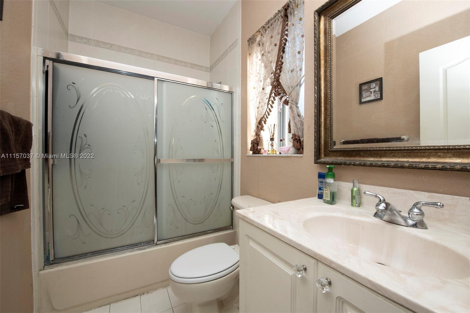 14738 Southwest 9th Lane Miami, FL 33194 - Photo 15 of 30 a bathroom with a granite countertop sink toilet and shower