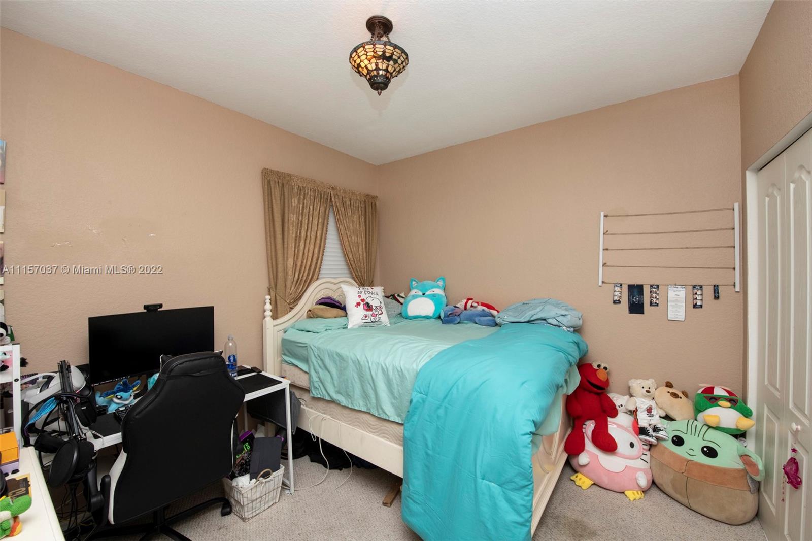 14738 Southwest 9th Lane Miami, FL 33194 - Photo 16 of 30 a bedroom with a bed and a window