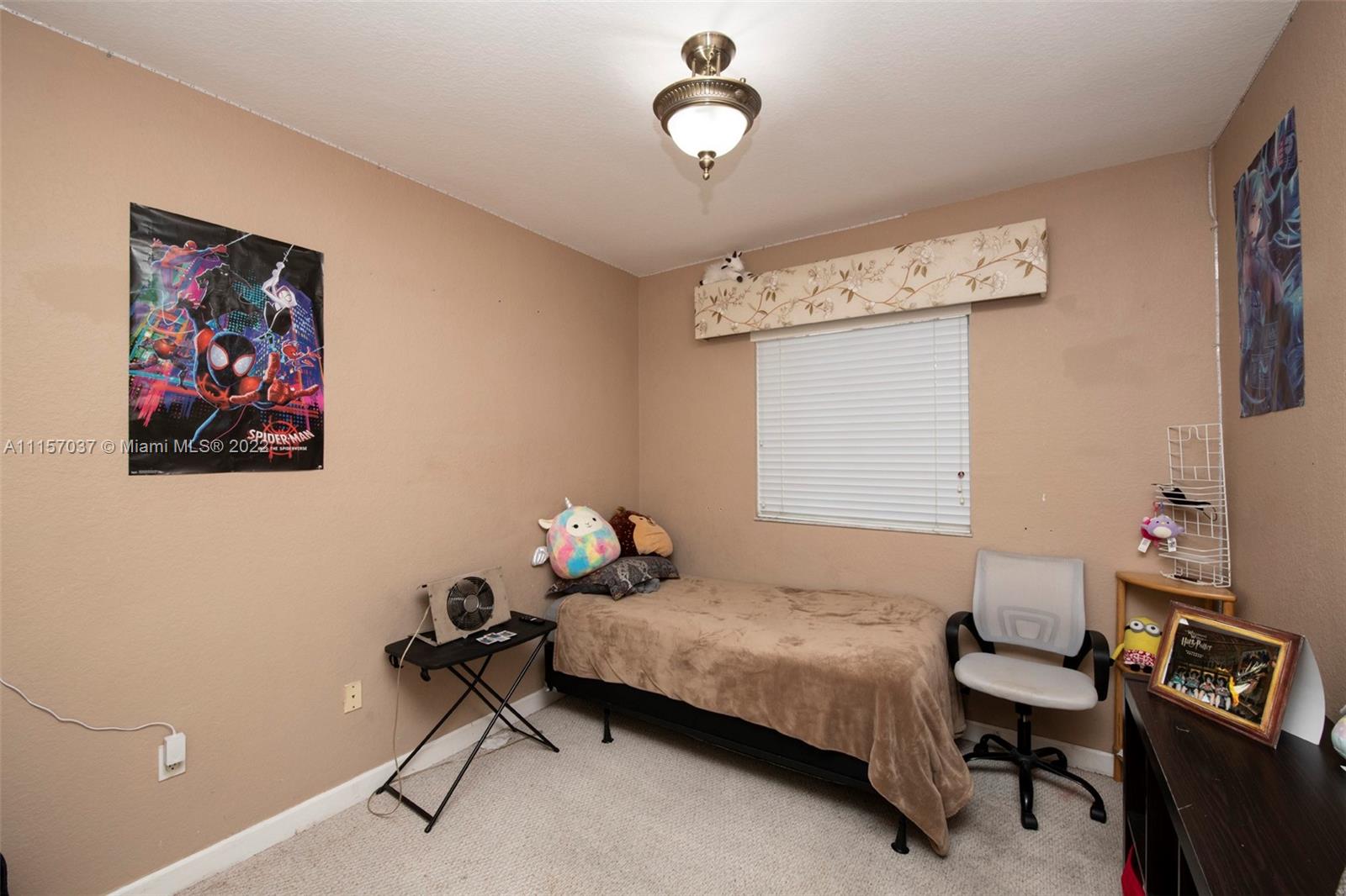 14738 Southwest 9th Lane Miami, FL 33194 - Photo 18 of 30 a bedroom with a bed a desk and chair