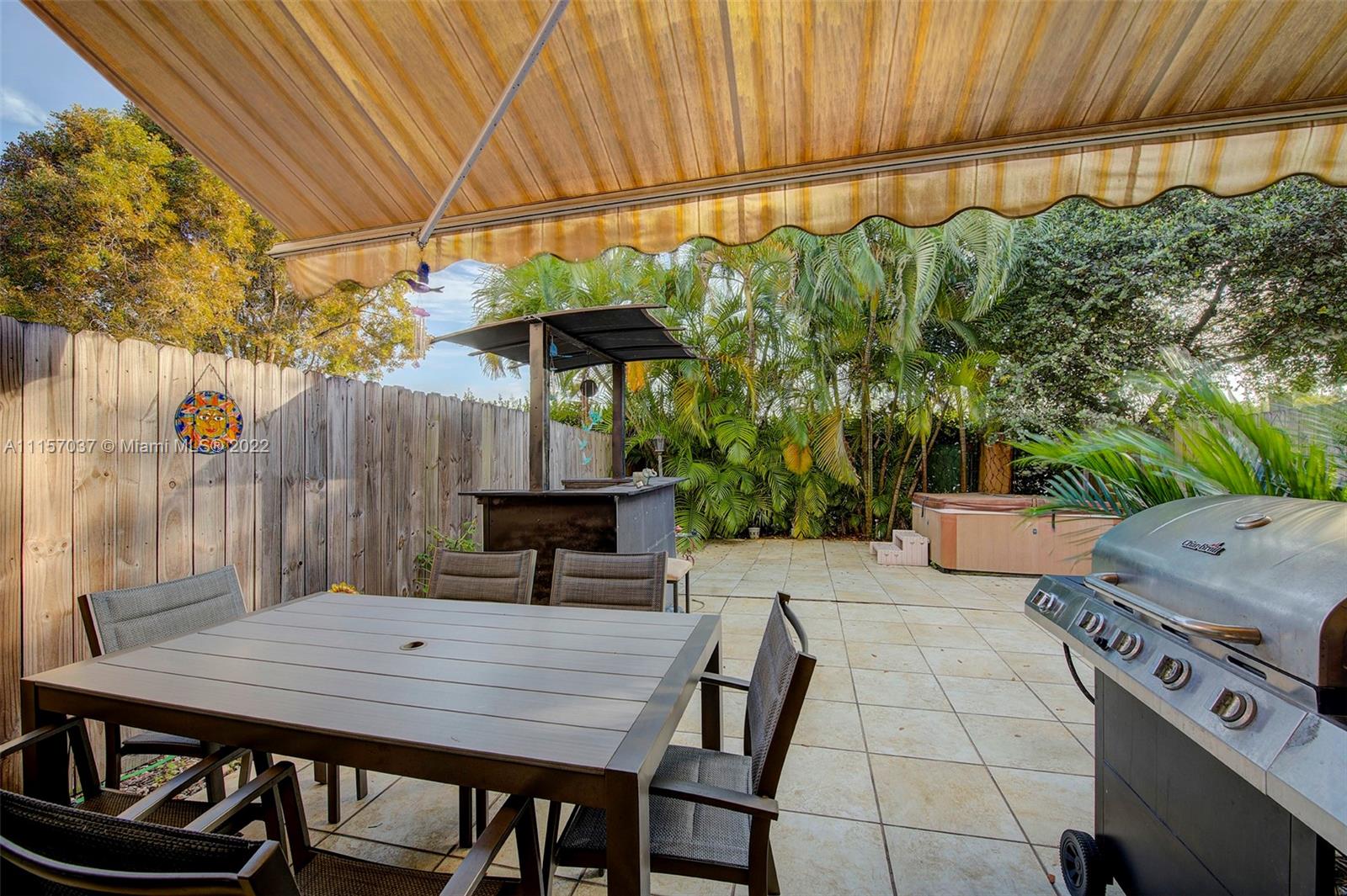 14738 Southwest 9th Lane Miami, FL 33194 - Photo 21 of 30 a view of a patio with table and chairs under an umbrella