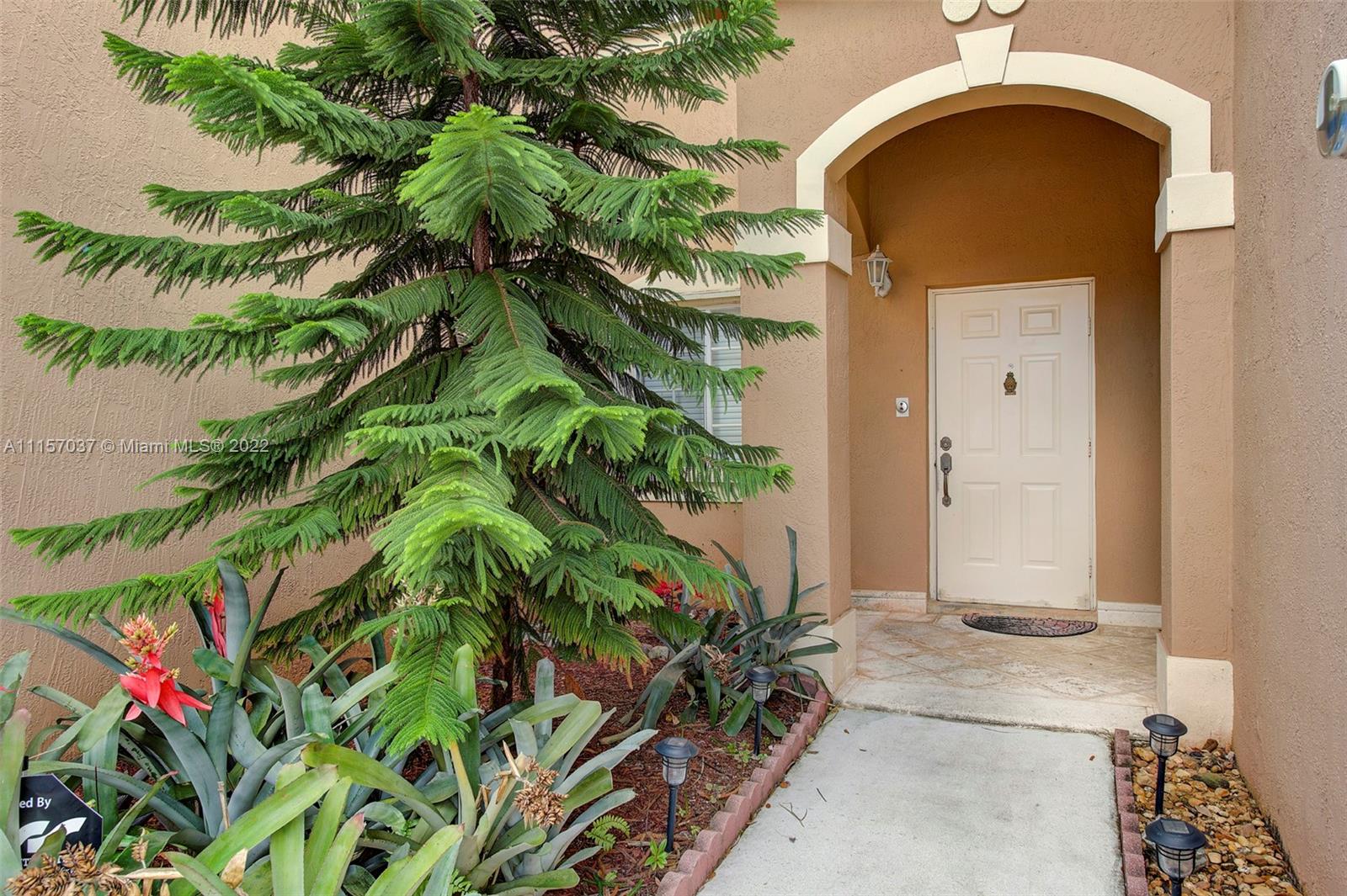 14738 Southwest 9th Lane Miami, FL 33194 - Photo 4 of 30 an entrance to house with yard