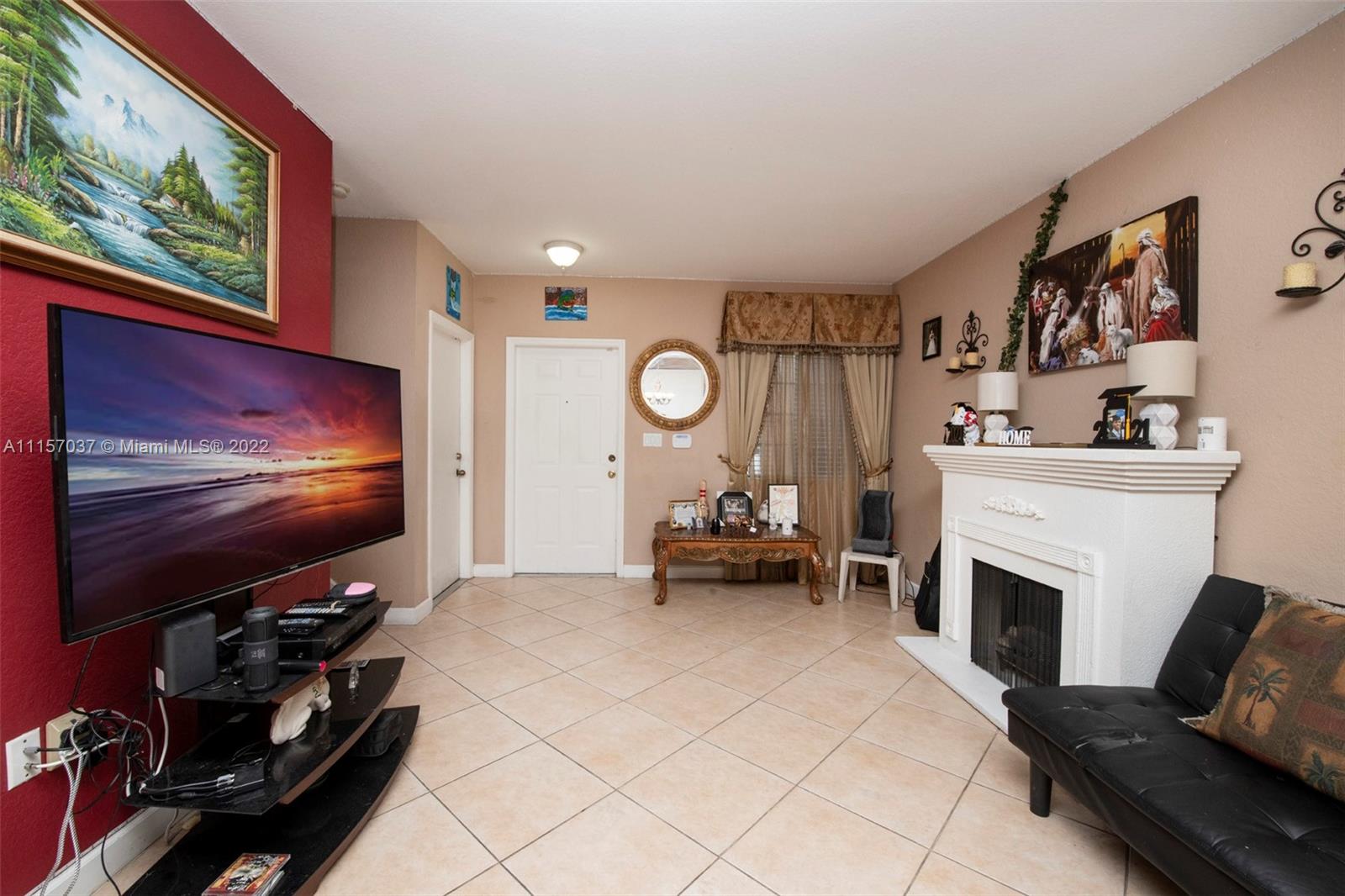 14738 Southwest 9th Lane Miami, FL 33194 - Photo 6 of 30 a living room with furniture a flat screen tv and a fireplace