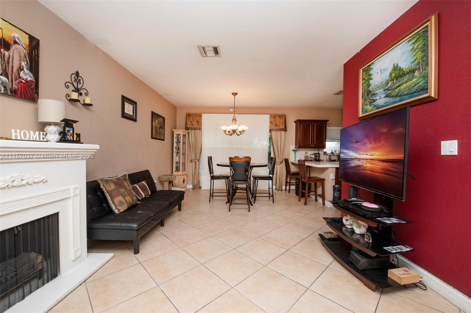 14738 Southwest 9th Lane Miami, FL 33194 - Photo 7 of 30 a living room with furniture a fireplace and a flat screen tv