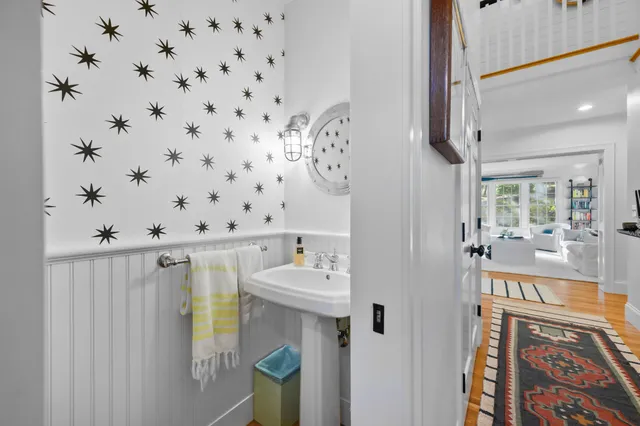 a bathroom with a bathtub sink and mirror