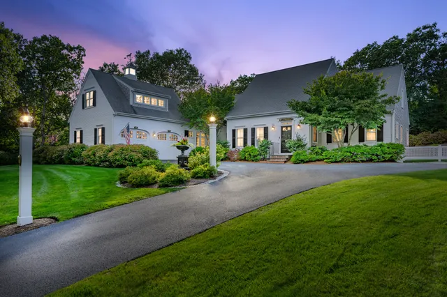 a view of a house with a yard and a street view