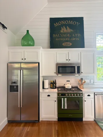 a kitchen with stainless steel appliances a stove a refrigerator and a stove