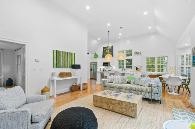 a living room with furniture fireplace and a table